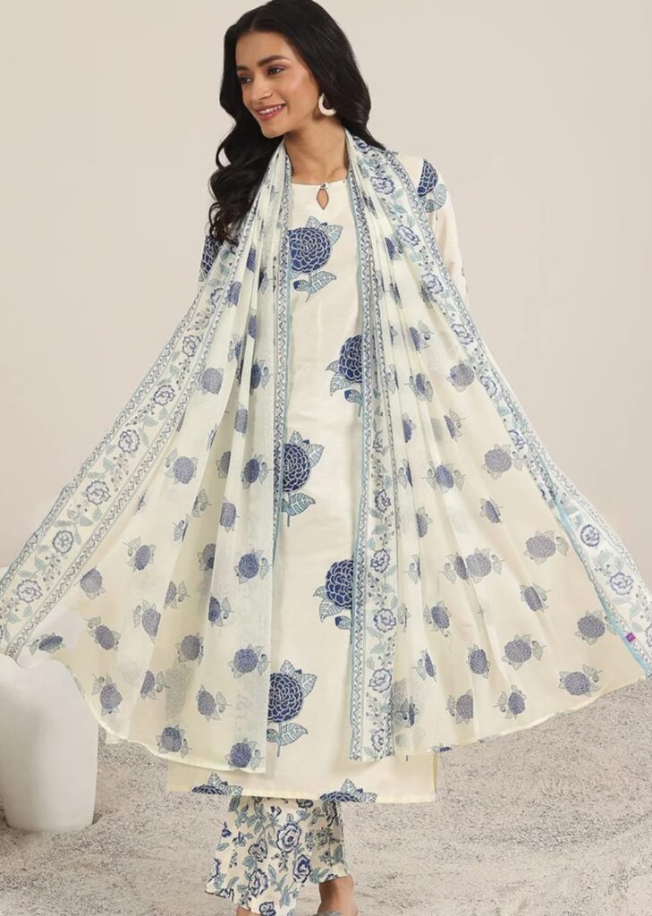 Woman wearing a printed three-piece kurta set with matching trousers and dupatta