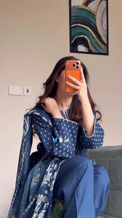 Seated view of blue printed kurta with matching trousers and floral dupatta