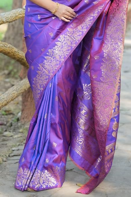 Close-up of the gold-tone floral border and pink-toned patterned pallu on a purple saree