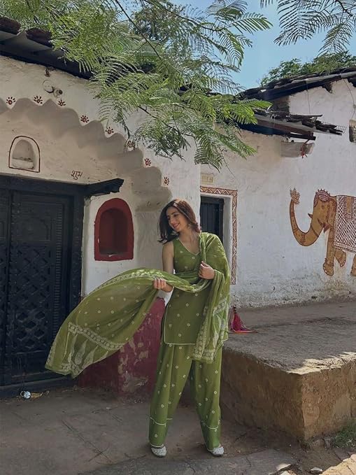 Olive green printed salwar suit with matching dupatta held out to show its border