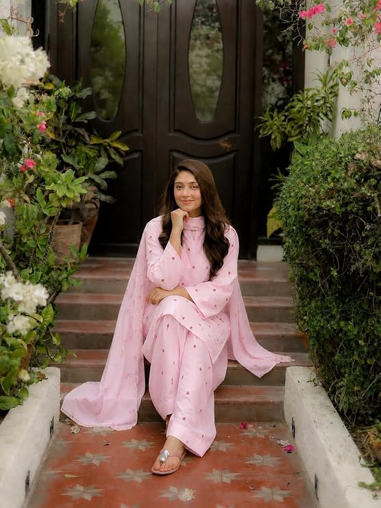 Model seated wearing a pink Farshi salwar suit with dupatta