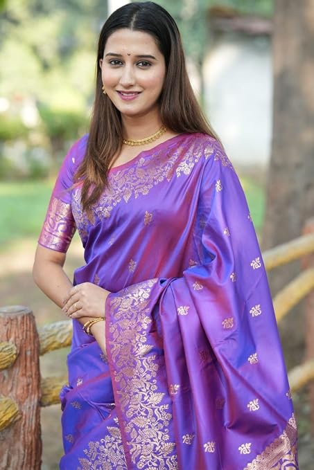 Purple saree draped over a coordinated blouse, showing gold-tone motifs and floral border
