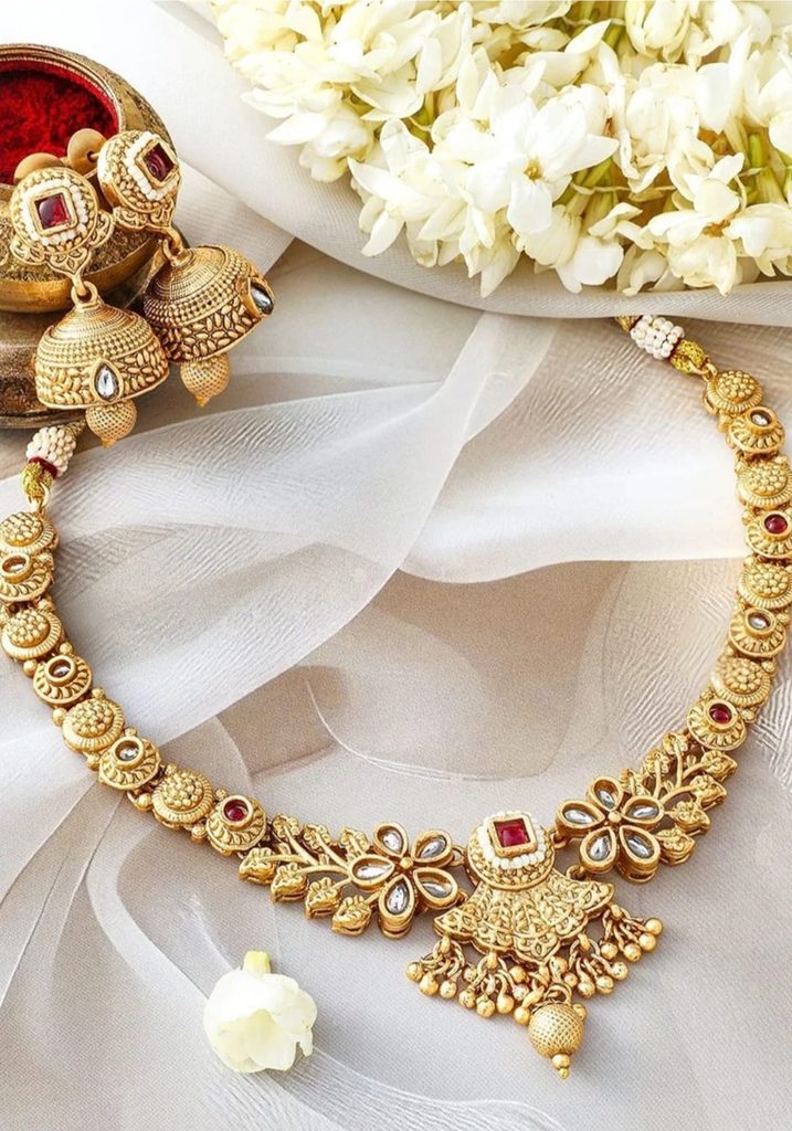 Rubans floral necklace and jhumkas with ruby-coloured and white stone accents