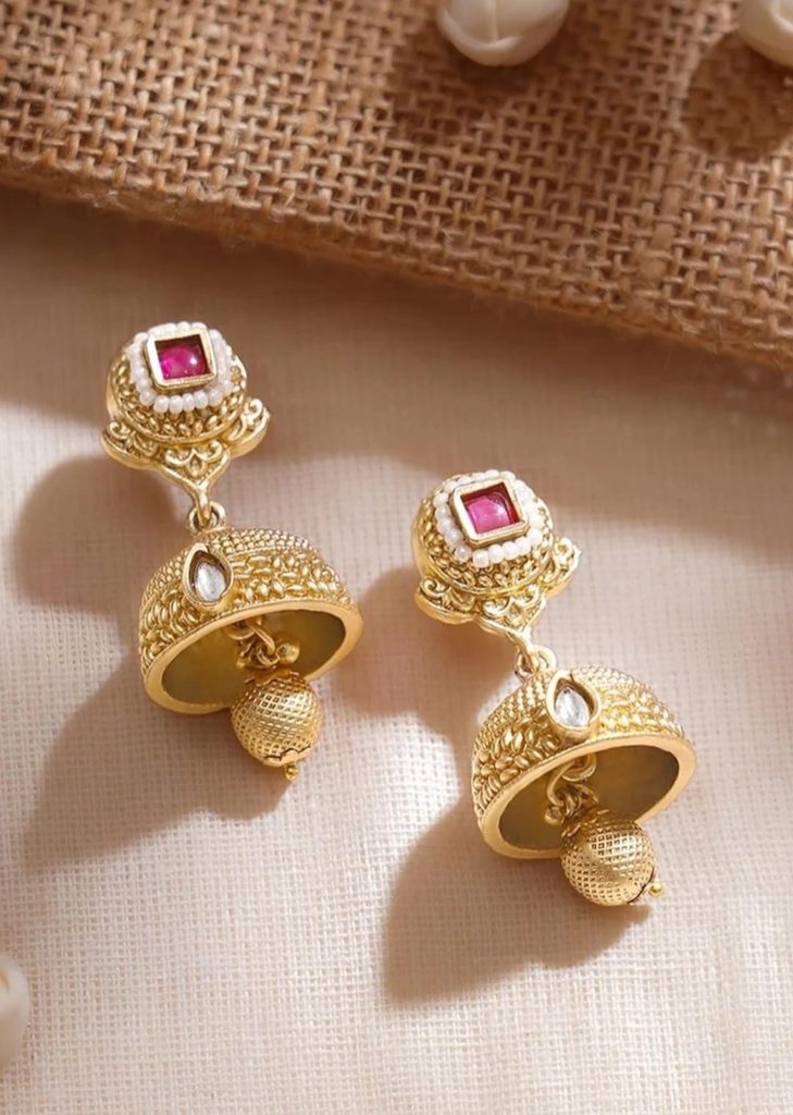 Close-up of Rubans gold-plated jhumkas with ruby-coloured square studs
