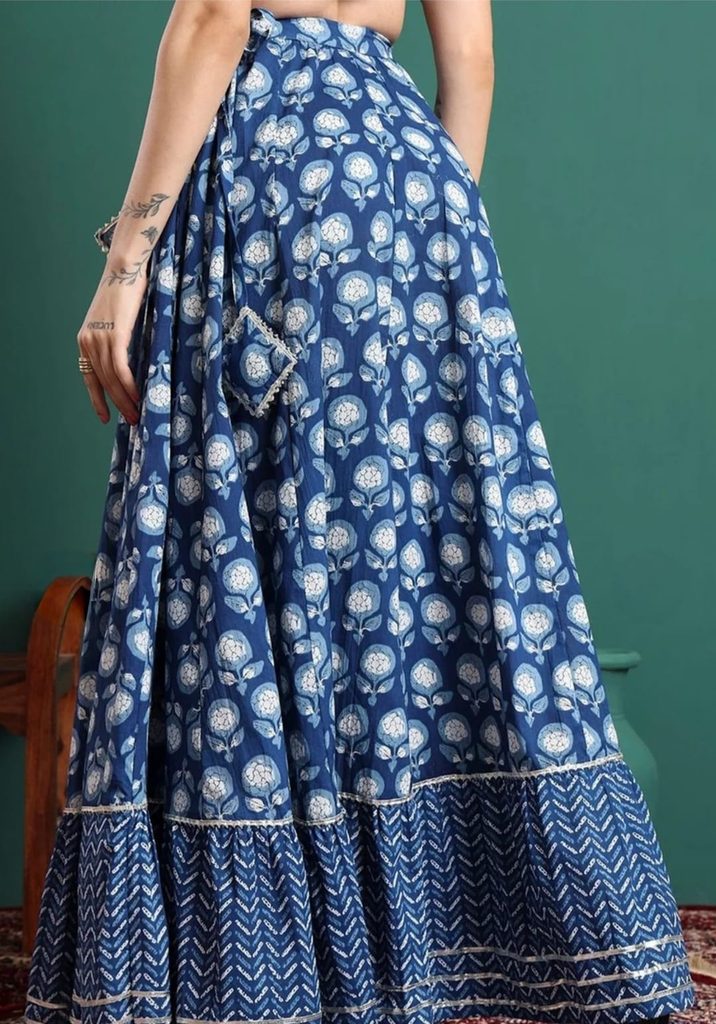 Angled view of CHARMANT blue printed flared maxi skirt