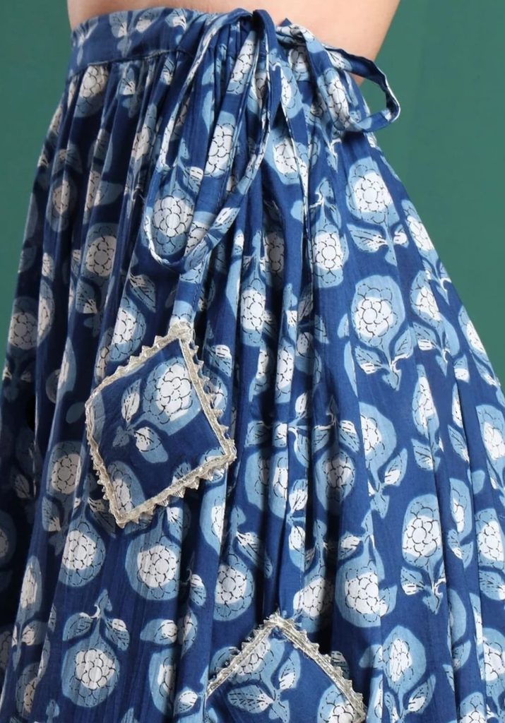 Side view of blue printed maxi skirt with decorative waist ties