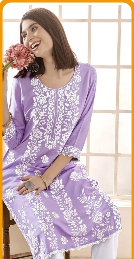 Woman wearing a lavender embroidered kurta styled with white trousers