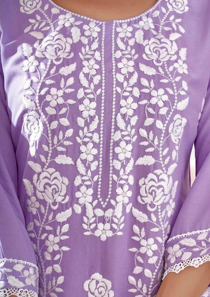 White floral embroidery around the round neckline of lavender Chikankari kurta