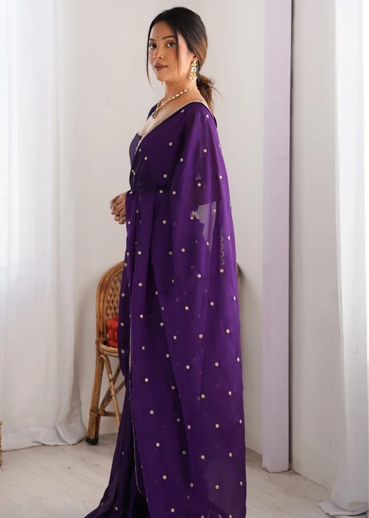 Side view of purple sequinned saree with draped pallu
