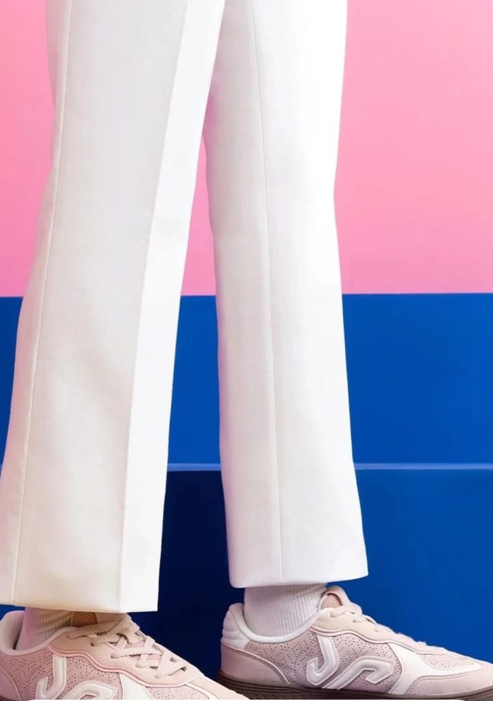 Campus pink sneakers styled with white wide-leg trousers