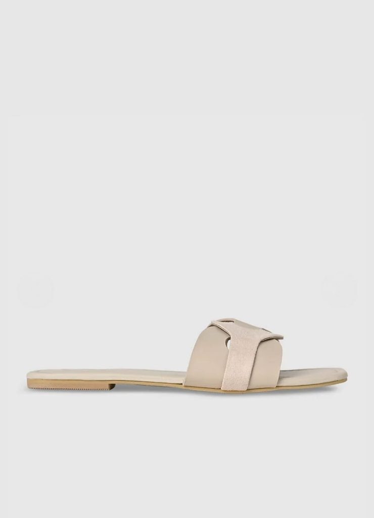 Rear angled view of CAI beige slip-on flat sandal